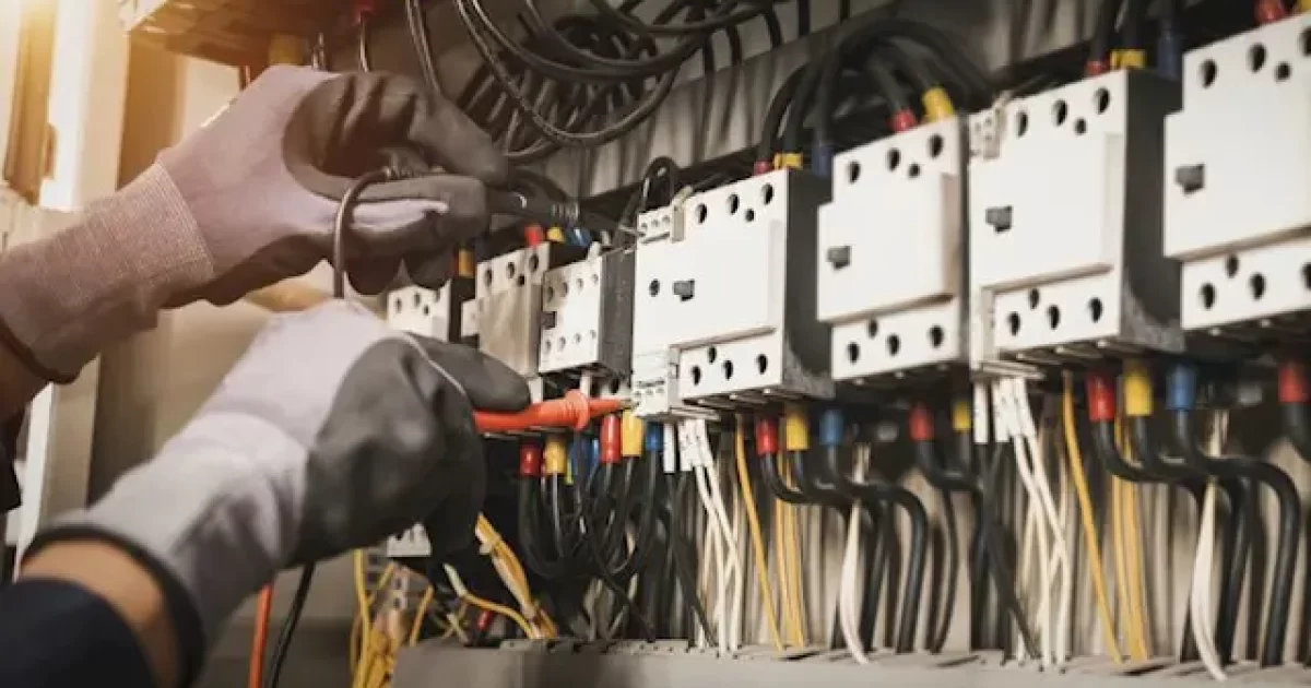 Commercial electrician installing electrical wiring in a Hawke’s Bay business building
